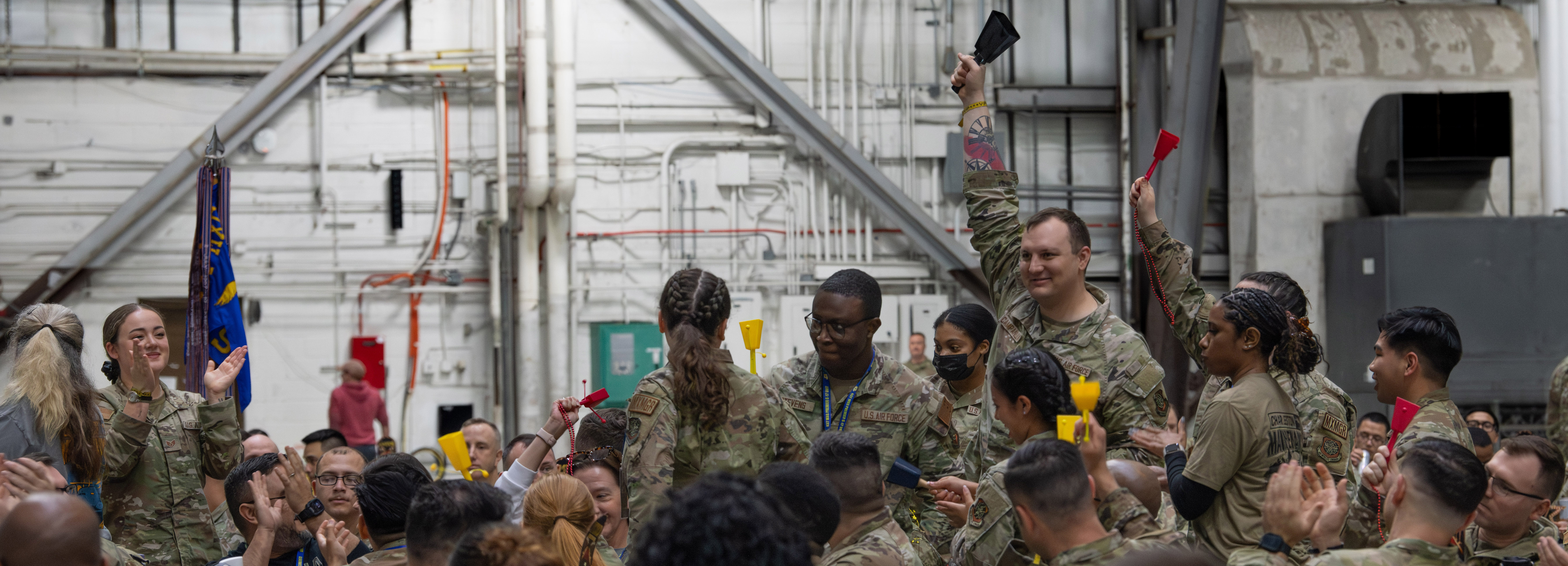 A group of maintainers cheer for winners at the ceremony.
